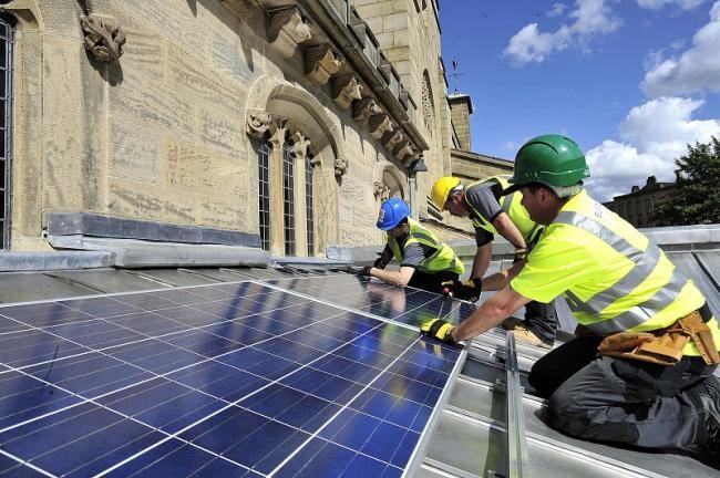 Solar panels being fitted on to a church